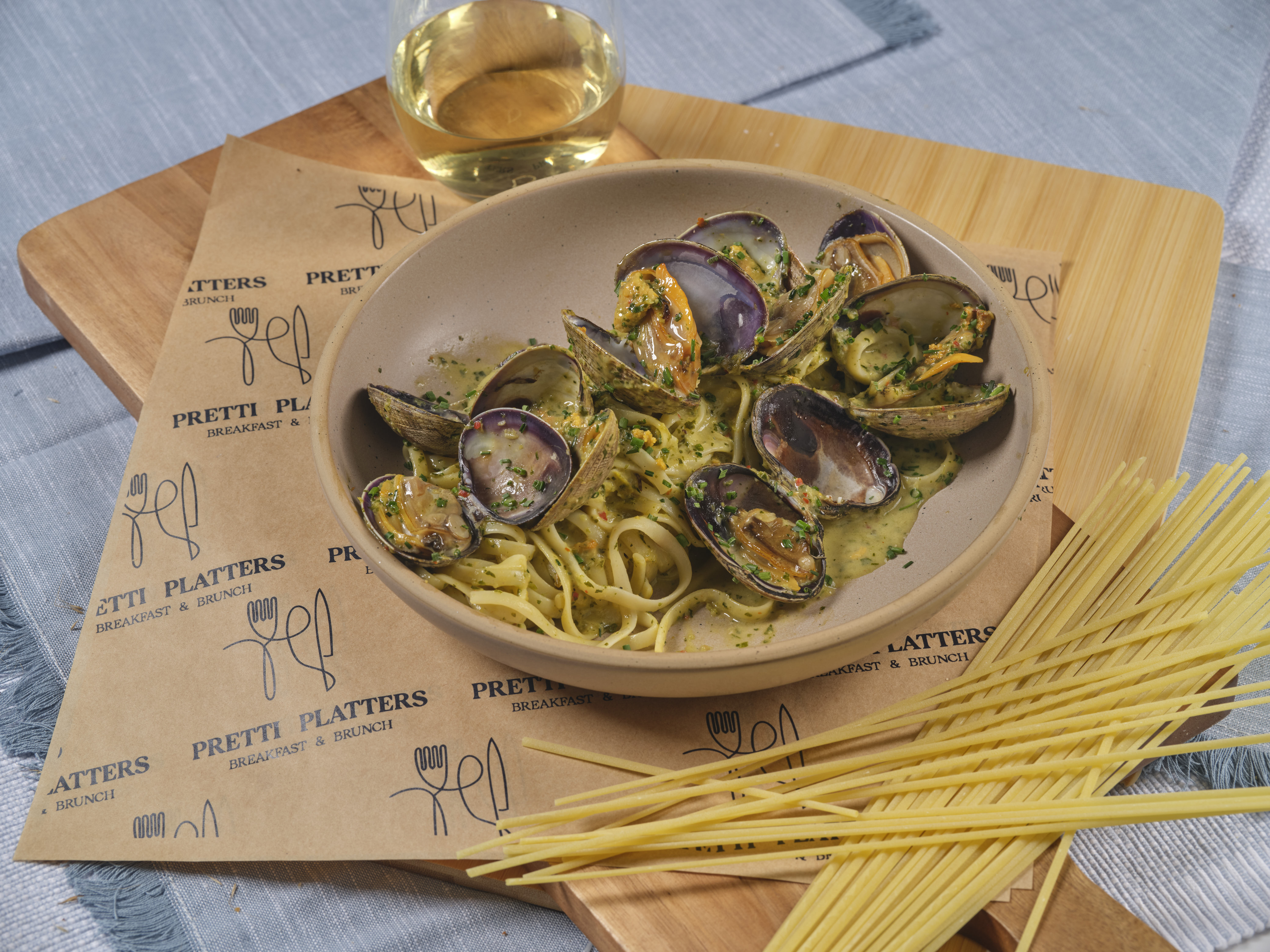Coastal Clam Linguini with plump Manila clams in a velvety cream sauce with salsa verde at Prettiplatters San Anselmo
