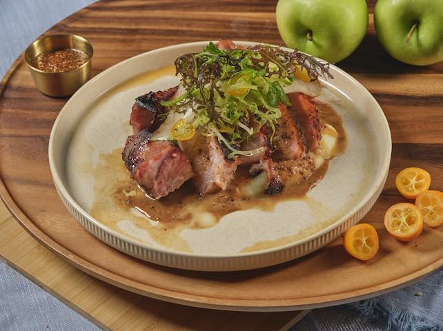 Heritage Pork Chop with celery root purée, green apple, broccolini, and mustard sauce at Prettiplatters